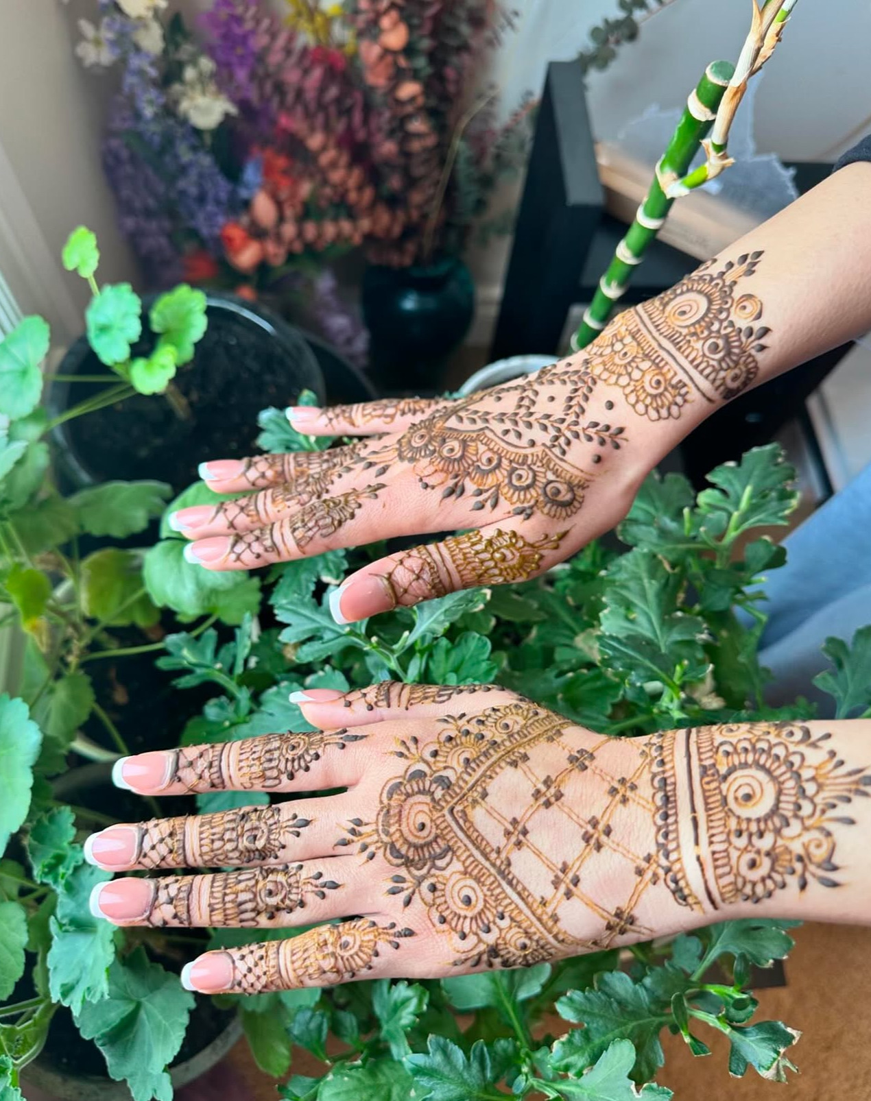 Matching henna hands with greenery background Edmonton